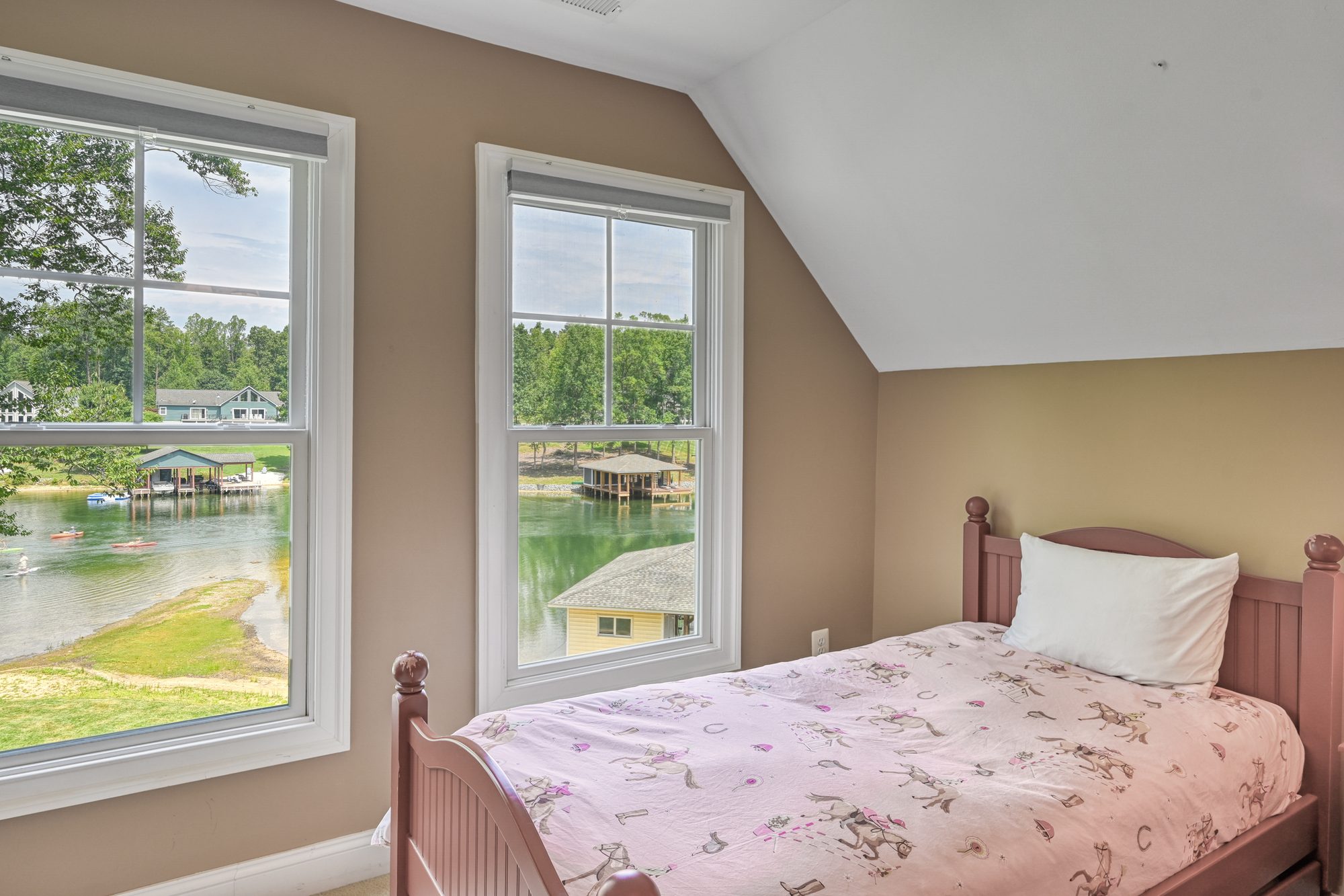 Kids room with cowgirl twin bed and lake-view windows